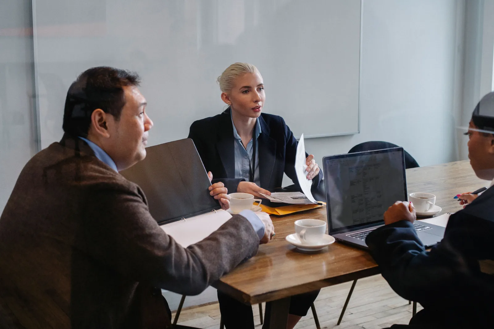 Nonprofit leadership team reviewing documents in a meeting